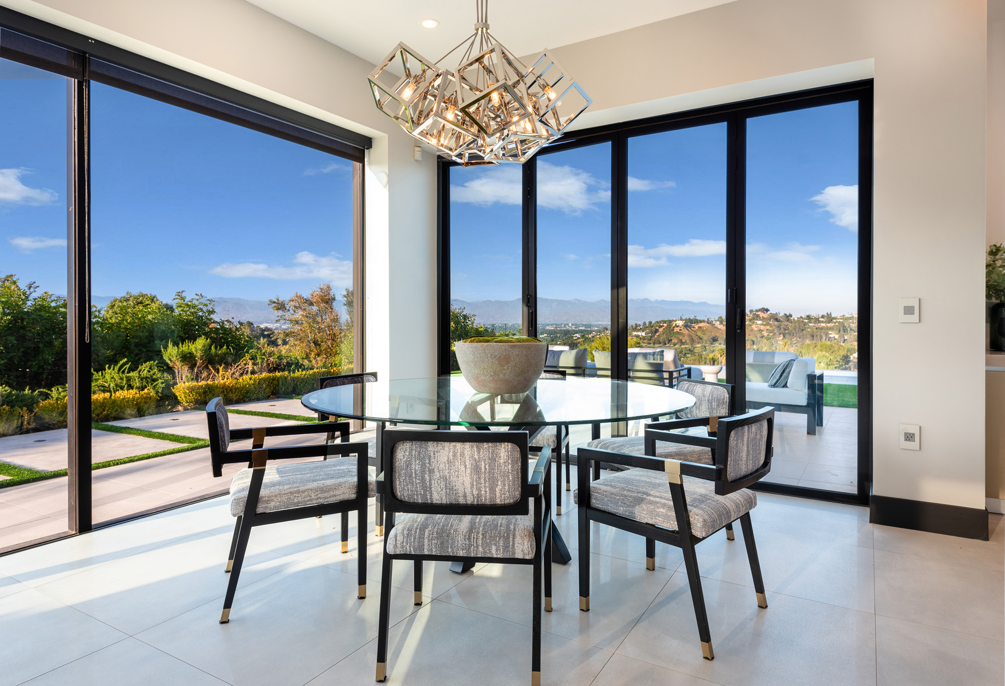 Gayle Quinta — dining area with chandelier and glass doors
