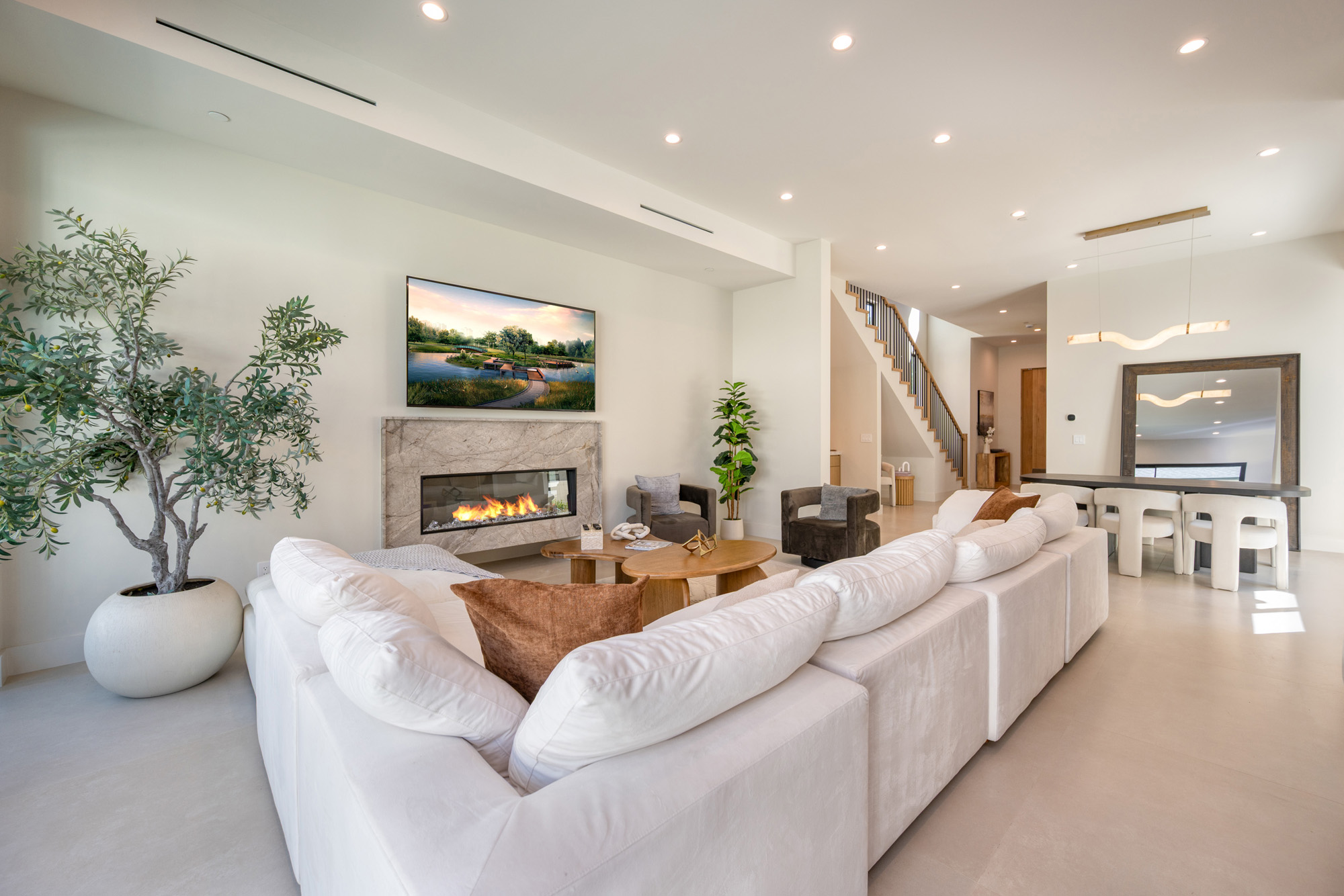 Atoll Lanai — living room with fireplace and double-height stair