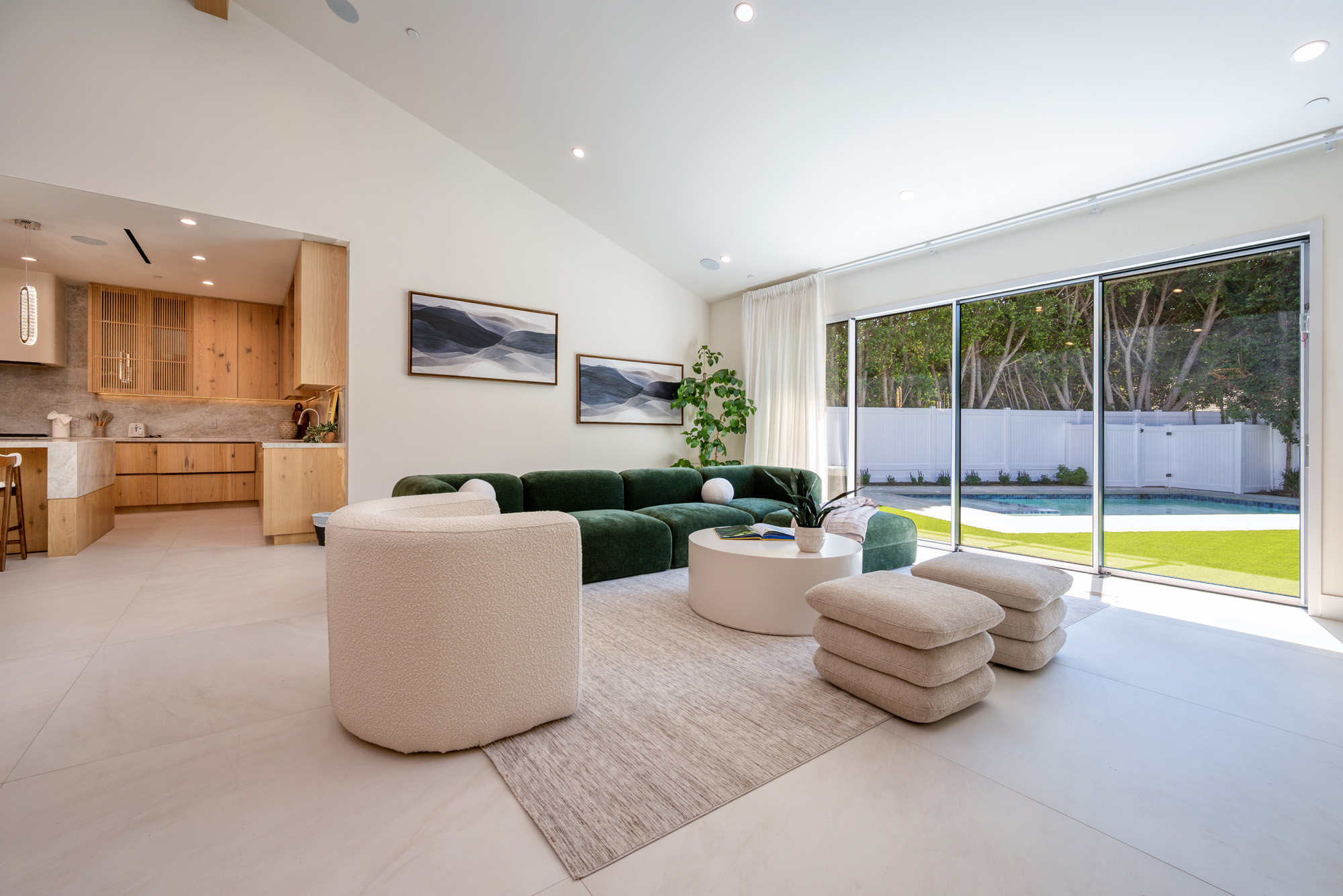 Woodley Orchard House — living room with green sofa opening to the lawn