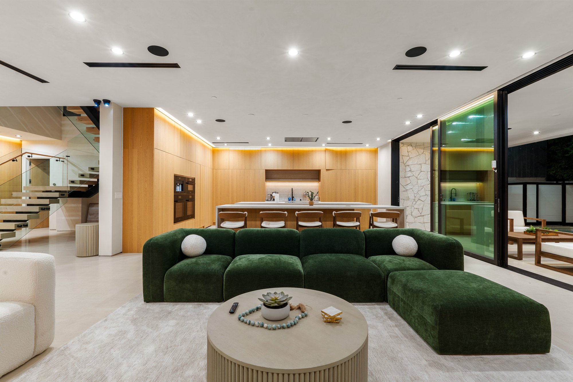 Curson Atelier — living room with green sofa and timber ceiling