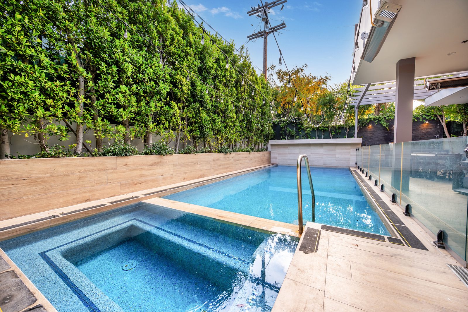 Croft Altana — pool and spa behind a hedge wall